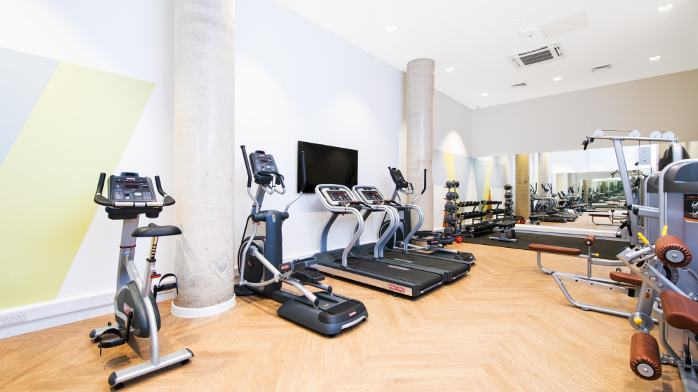 A gym with various exercise equipment
